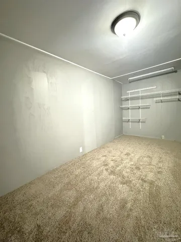 an empty room with a empty space and exposed radiator