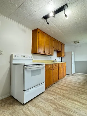a kitchen with a sink stove and cabinets