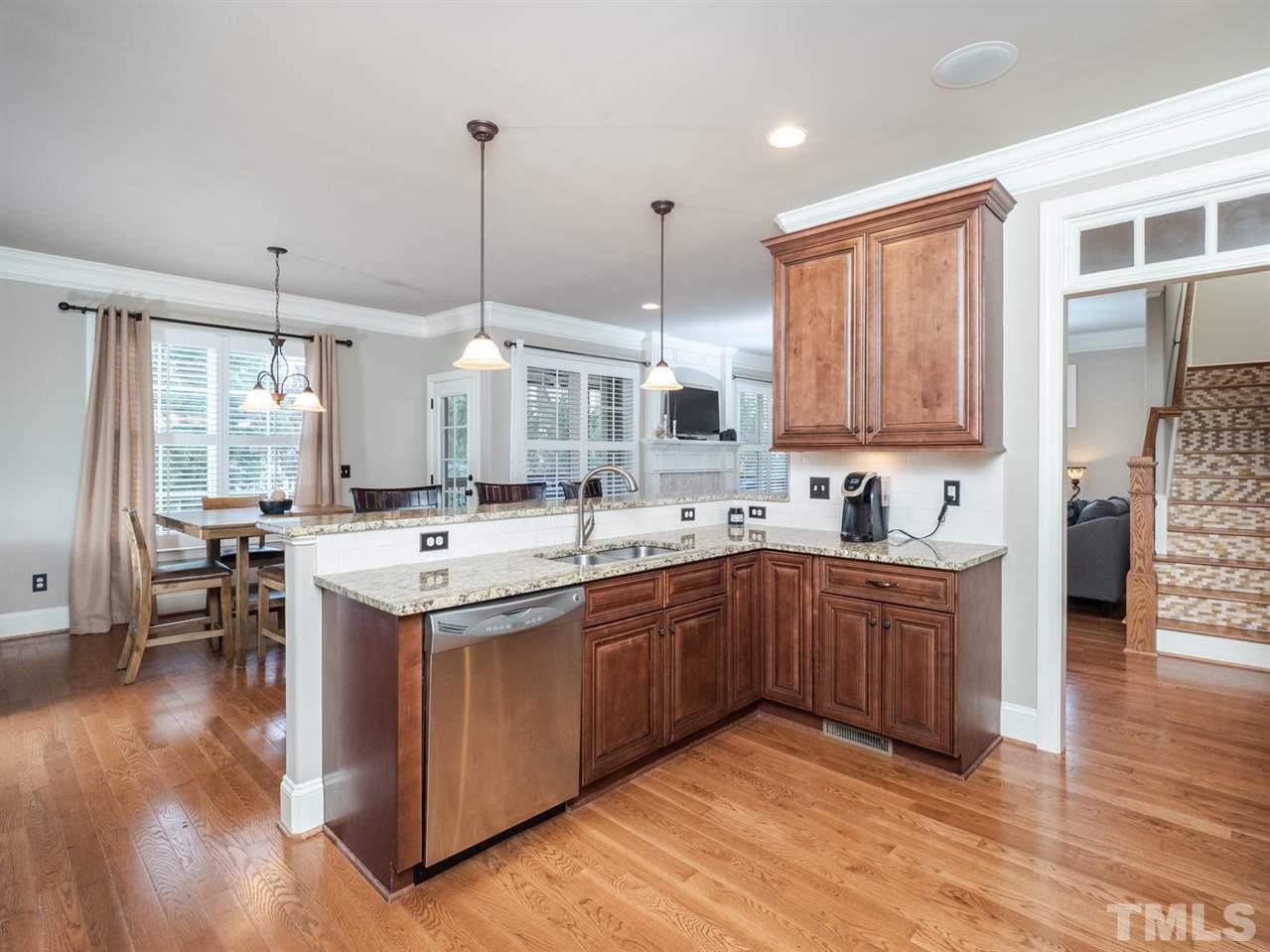 12804 Pegasi Way Raleigh, NC 27614 - Photo 8 of 30 a kitchen with stainless steel appliances granite countertop a sink a stove and a wooden floors
