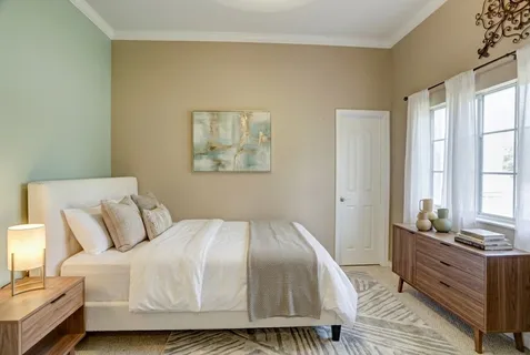 a bedroom with a bed and a dresser
