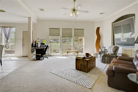 a living room with furniture and large windows