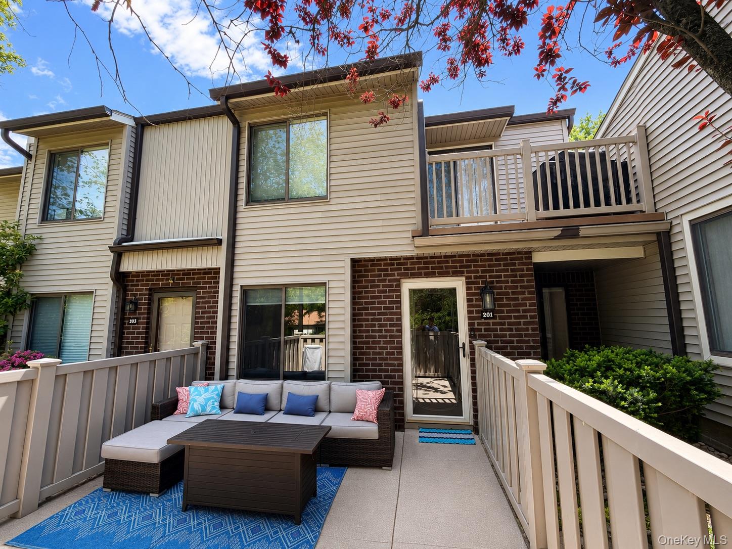 a view of a house with a couches on the deck