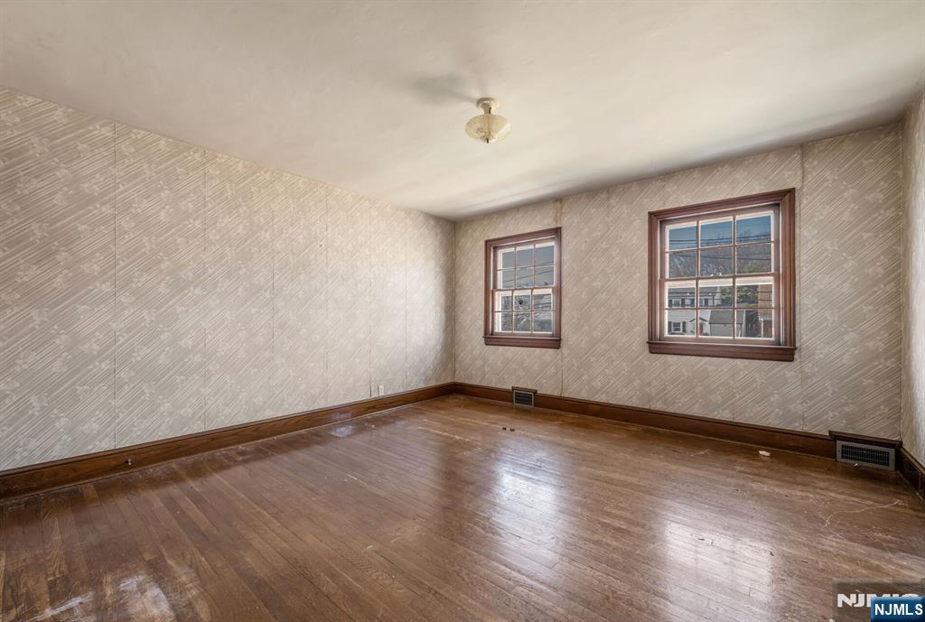 164 Chestnut Street Garfield, NJ 07026 - Photo 12 of 20 a view of an empty room with wooden floor and a window