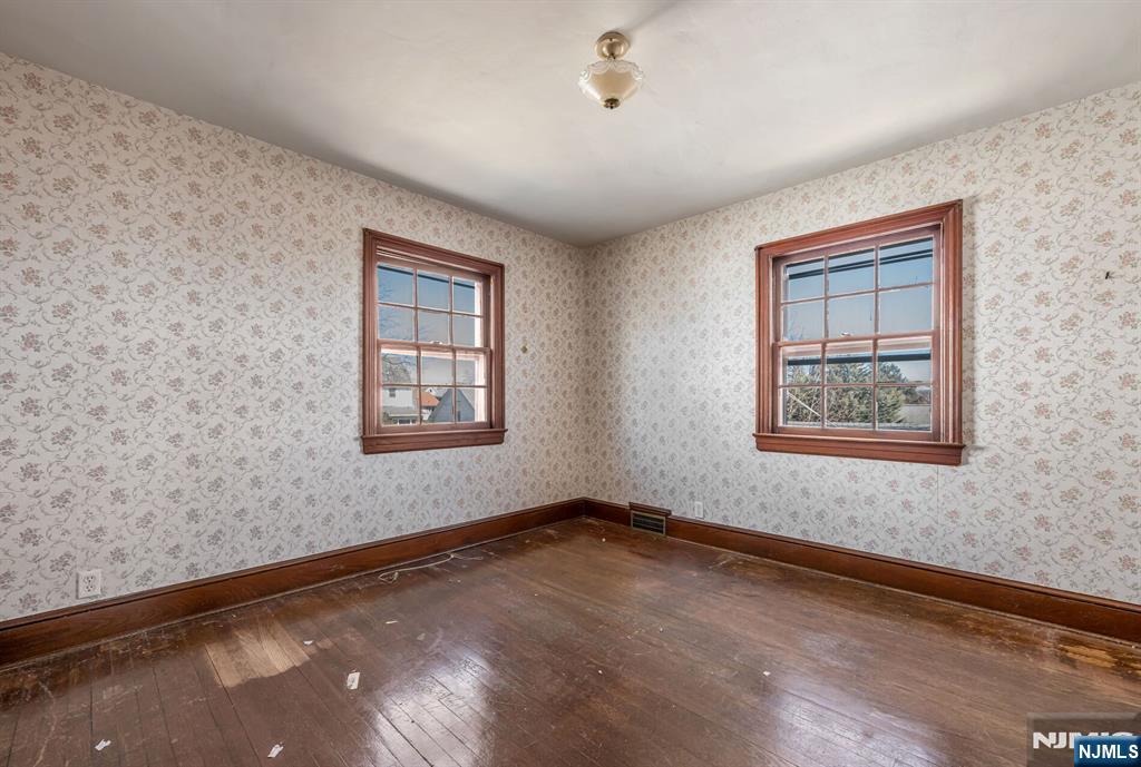 164 Chestnut Street Garfield, NJ 07026 - Photo 14 of 20 a view of an empty room with a window and wooden floor
