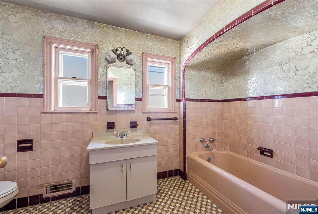 164 Chestnut Street Garfield, NJ 07026 - Photo 15 of 20 a bathroom with a sink a toilet and shower