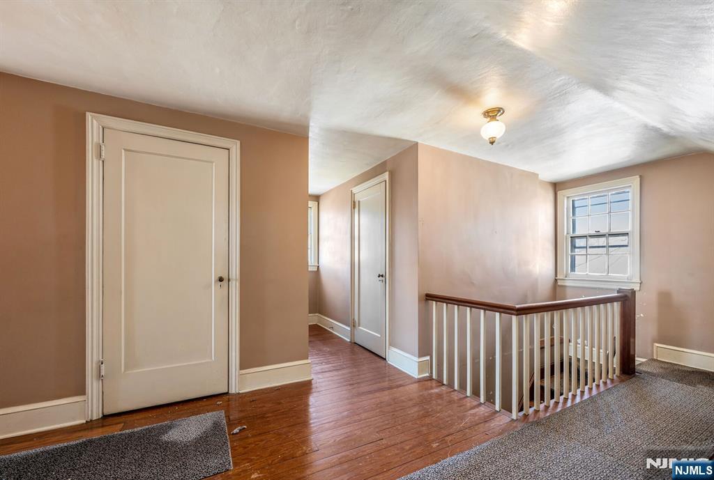 164 Chestnut Street Garfield, NJ 07026 - Photo 16 of 20 a view of a hallway with wooden floor and windows