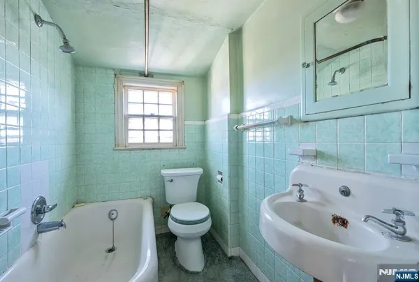 a bathroom with a sink a toilet and bathtub