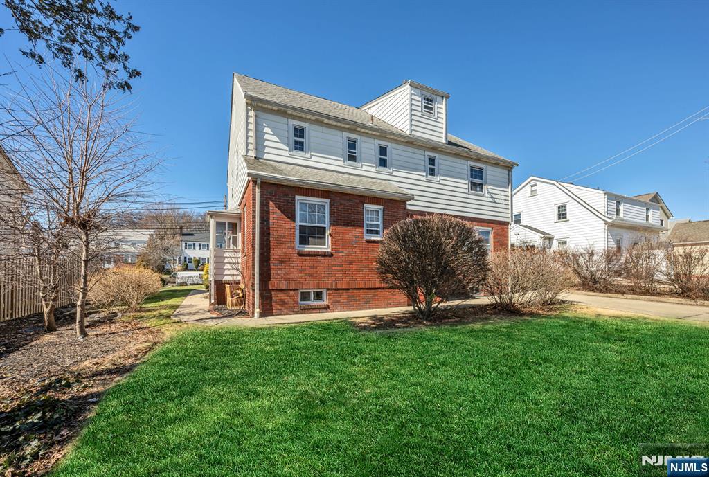 164 Chestnut Street Garfield, NJ 07026 - Photo 2 of 20 a front view of a house with a yard