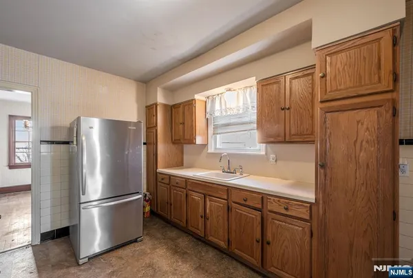 a kitchen with stainless steel appliances granite countertop a refrigerator a sink and dishwasher