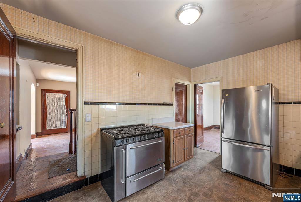 164 Chestnut Street Garfield, NJ 07026 - Photo 8 of 20 a kitchen with a refrigerator a stove and a sink