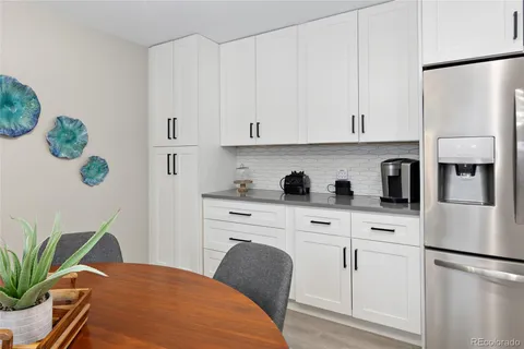 a view of a dining room with furniture and a window