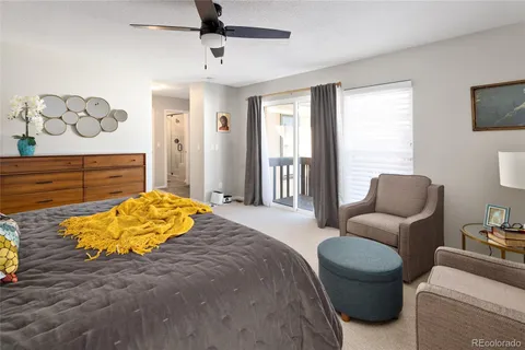 a bed room with a bed and a chair