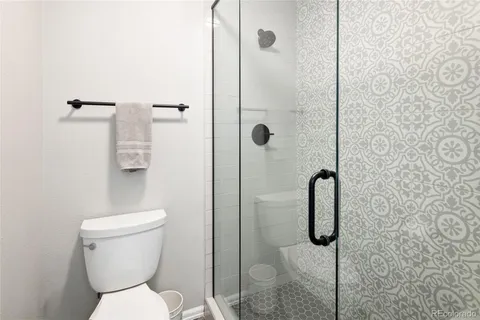 an aerial view of a house with a garden and lake view