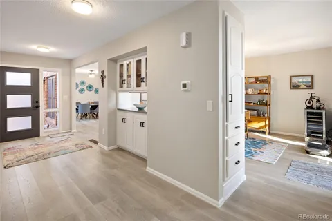 a view of a bedroom with wooden floor and windows