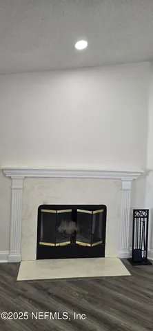 a kitchen with a sink a refrigerator and wooden floor