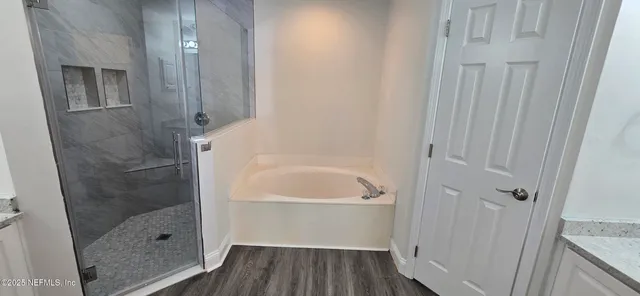 a bathroom with a bathtub shower sink and toilet
