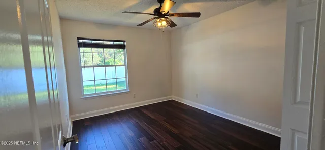 a bathroom with a granite countertop sink a large mirror and a vanity