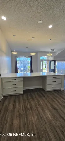 a utility room with wooden floor and a fireplace