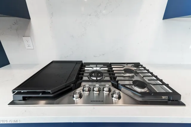 a kitchen with a sink a counter and chairs