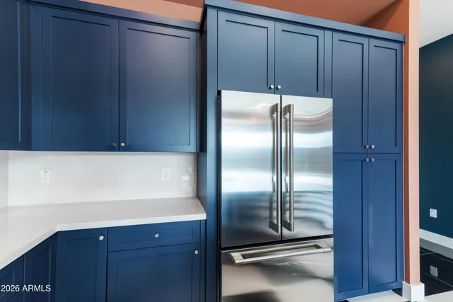 a kitchen with wooden cabinets and stainless steel appliances