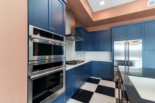 a room with a black white checkered floor with a gaming machine and a fireplace