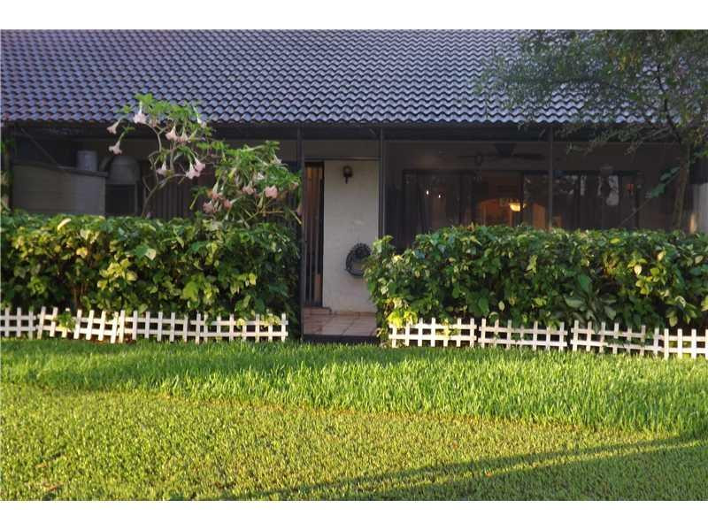 16137 Laurel Drive, Unit 32 Weston, FL 33326 - Photo 2 of 9 a front view of a house with a garden