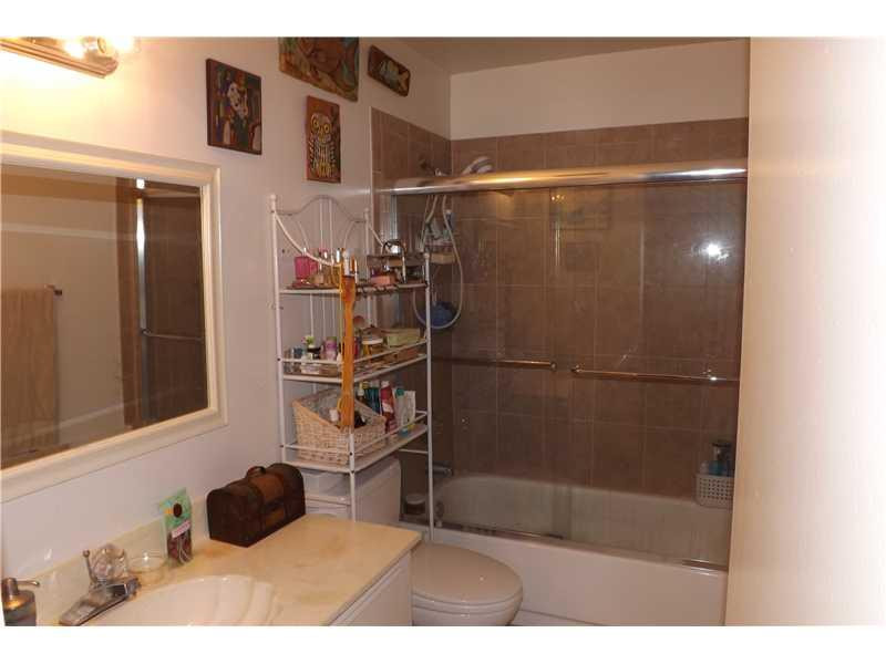 16137 Laurel Drive, Unit 32 Weston, FL 33326 - Photo 6 of 9 a bathroom with a bathtub and a shower