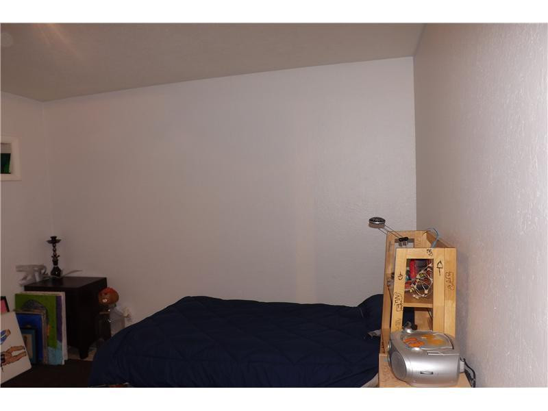 16137 Laurel Drive, Unit 32 Weston, FL 33326 - Photo 8 of 9 a living room with a bed