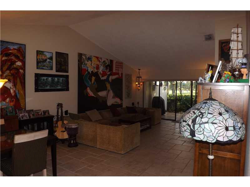 16137 Laurel Drive, Unit 32 Weston, FL 33326 - Photo 9 of 9 a living room with furniture and a flat screen tv