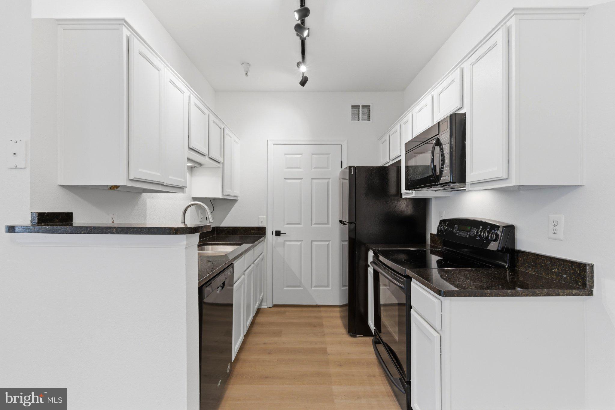 1580 Spring Gate Dr., Unit 4303 McLean, VA 22102 - Photo 8 of 41 Modern kitchen with sleek finishes.