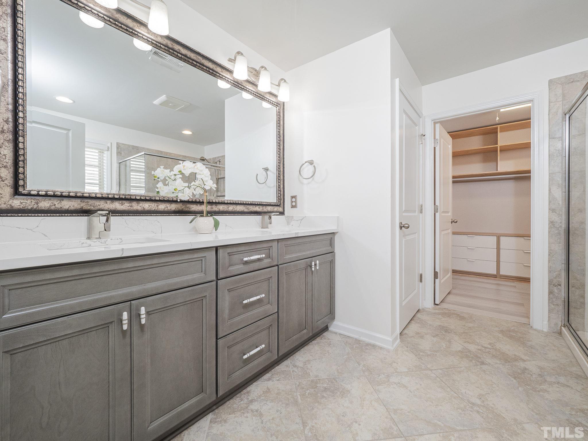 7435 Randshire Way Raleigh, NC 27616 - Photo 14 of 25 a spacious bathroom with a granite countertop sink mirror and double