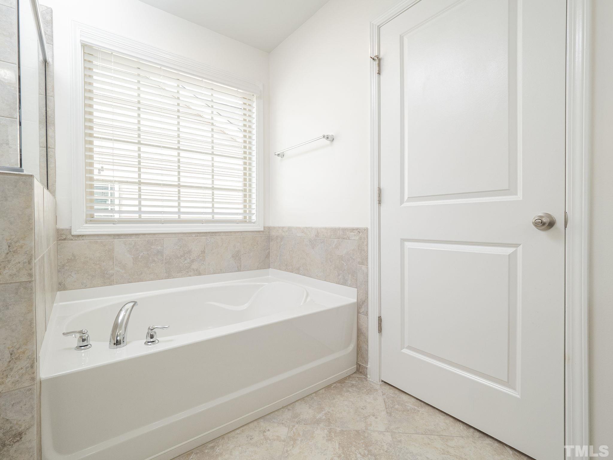 7435 Randshire Way Raleigh, NC 27616 - Photo 15 of 25 a white bath tub sitting next to a window