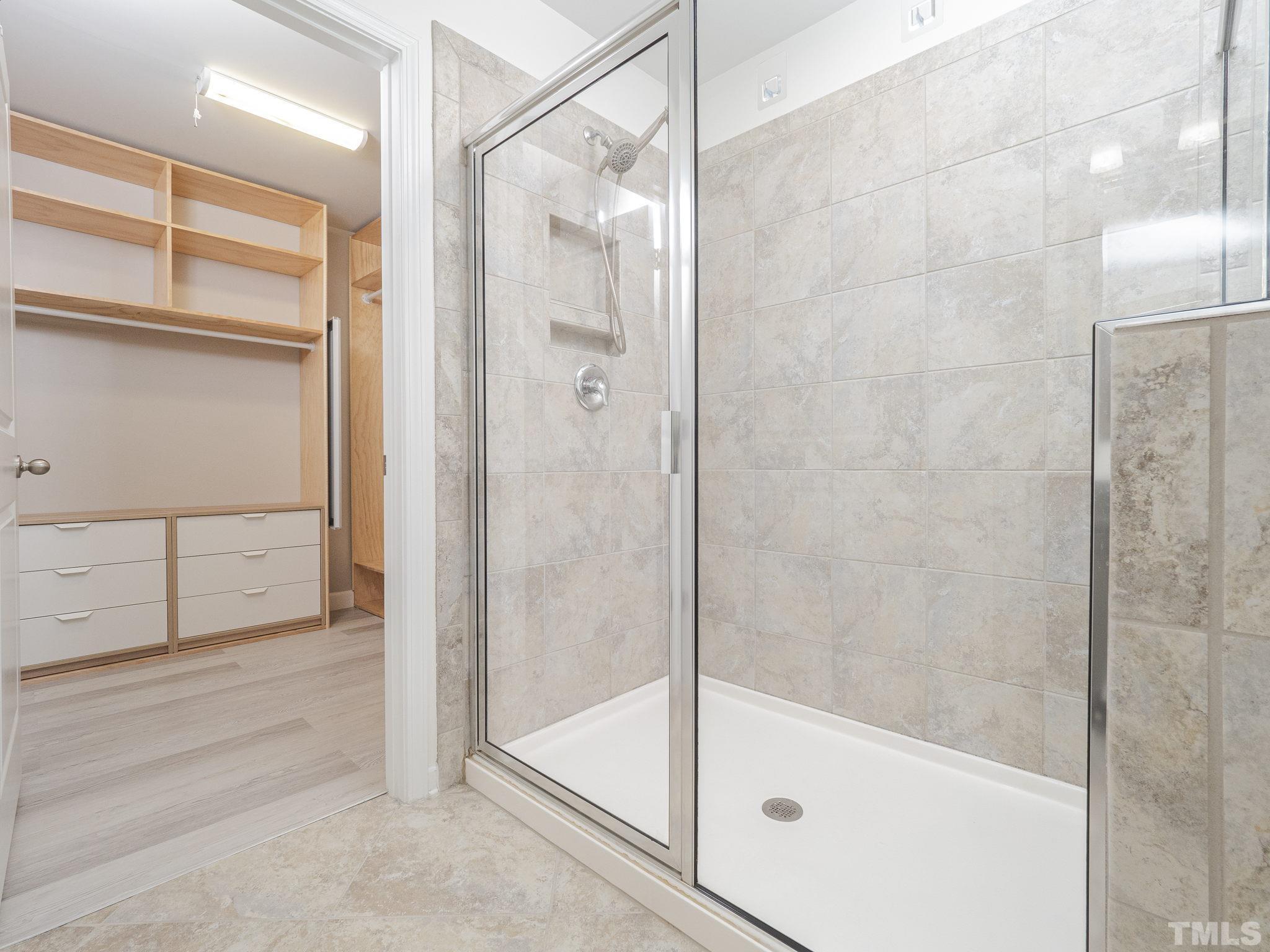 7435 Randshire Way Raleigh, NC 27616 - Photo 16 of 25 a bathroom with a glass shower door