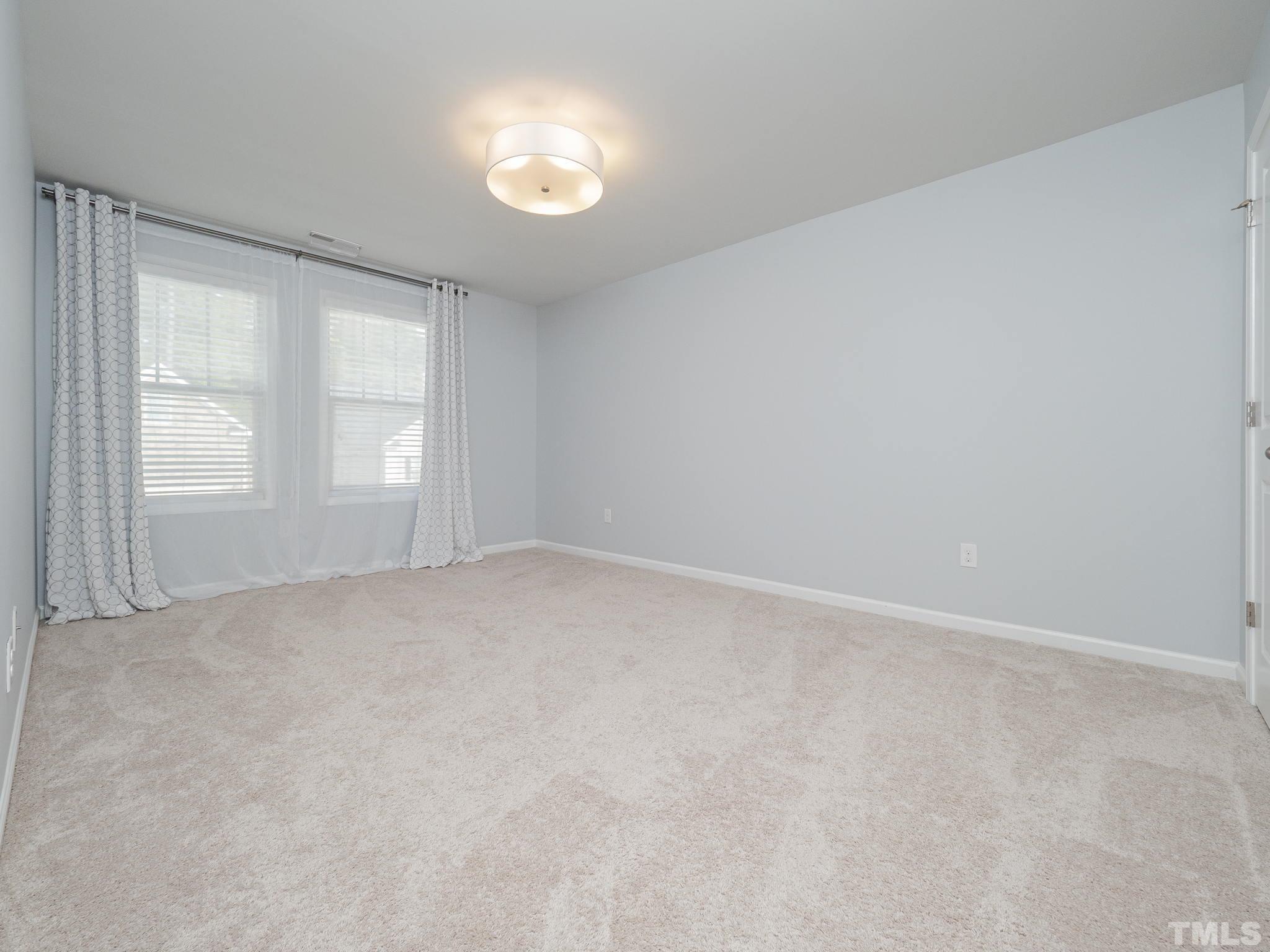7435 Randshire Way Raleigh, NC 27616 - Photo 17 of 25 an empty room with windows