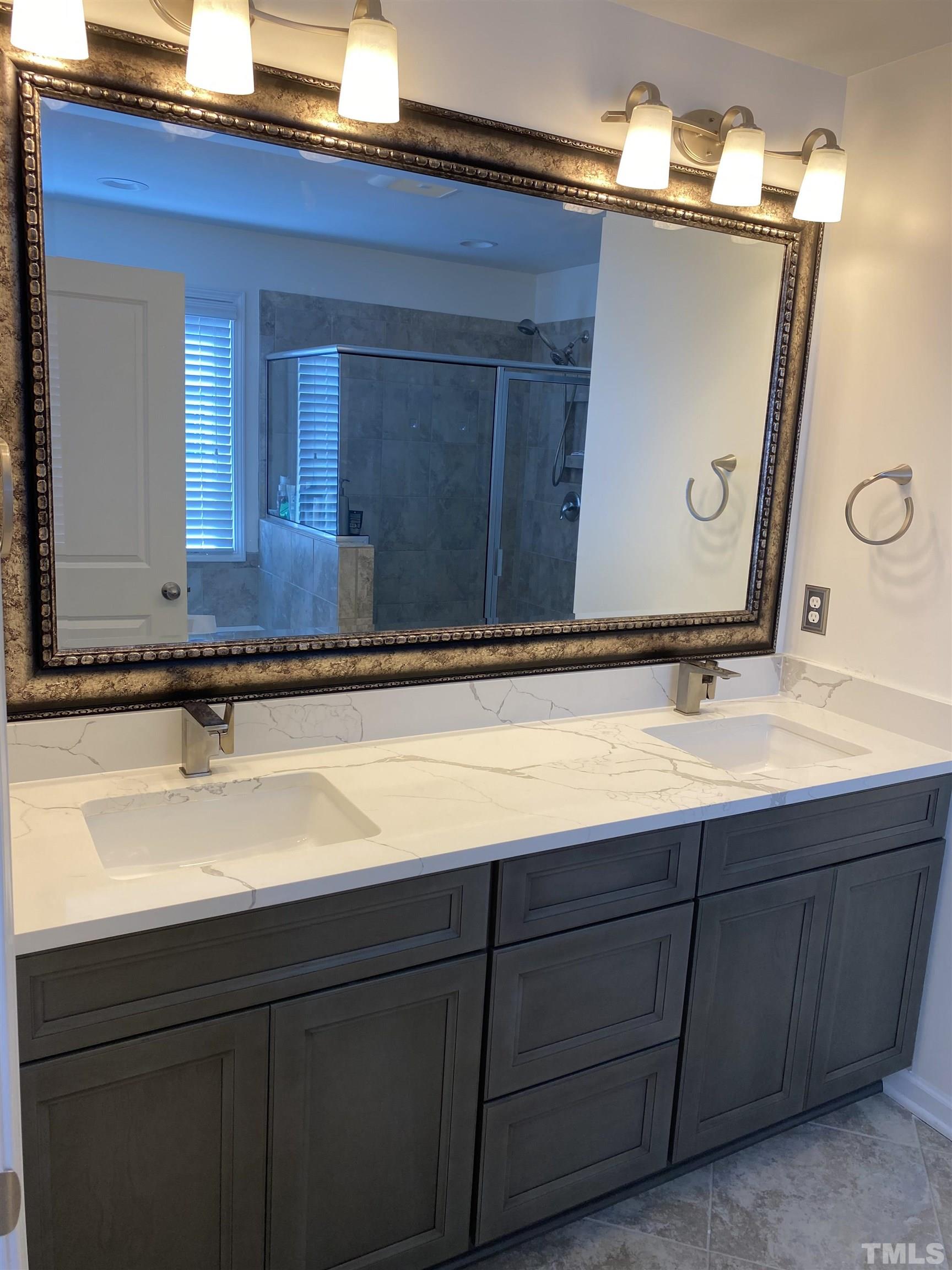 7435 Randshire Way Raleigh, NC 27616 - Photo 3 of 25 a bathroom with a sink and a mirror