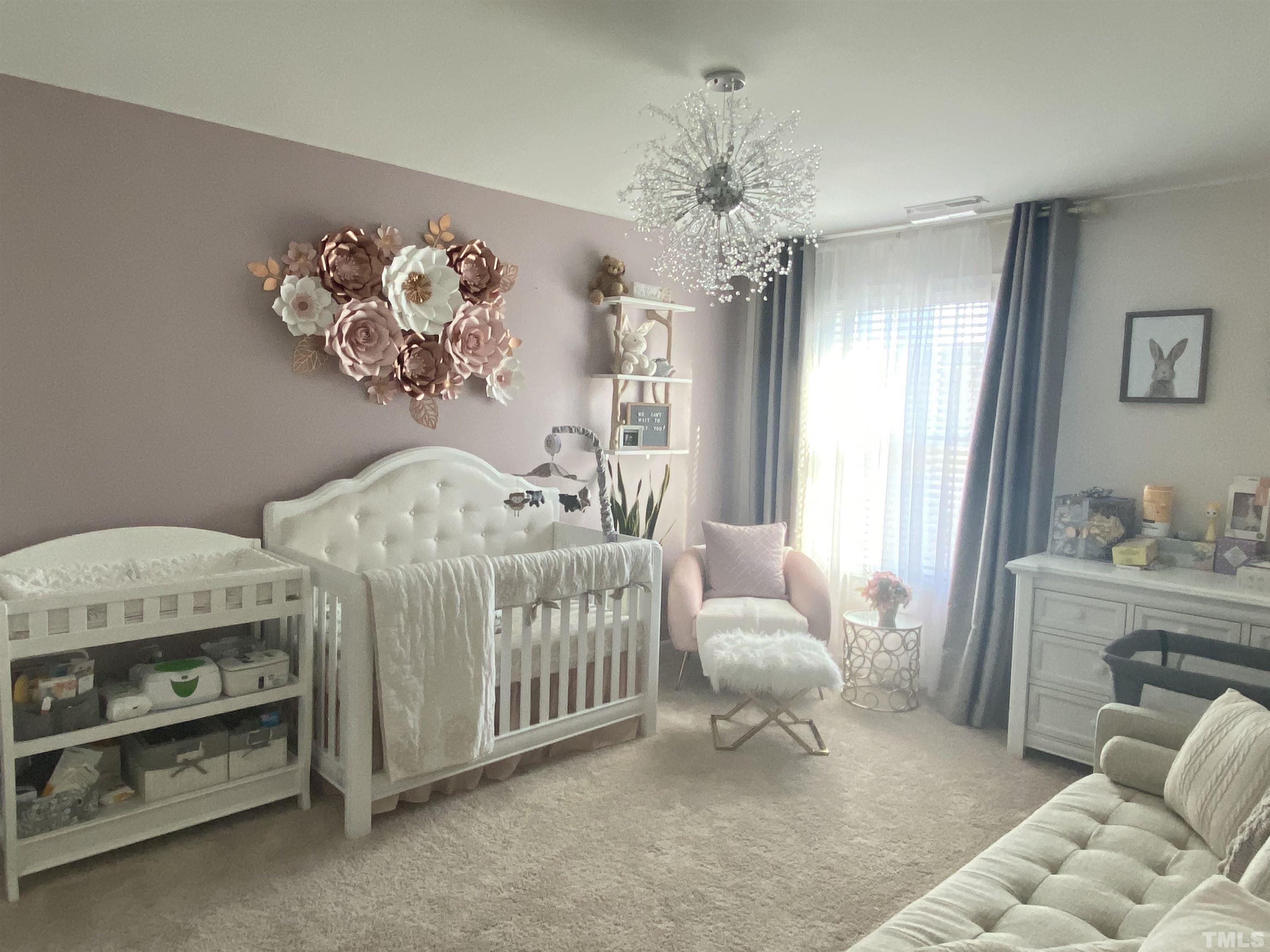 7435 Randshire Way Raleigh, NC 27616 - Photo 4 of 25 a bedroom with furniture and a chandelier