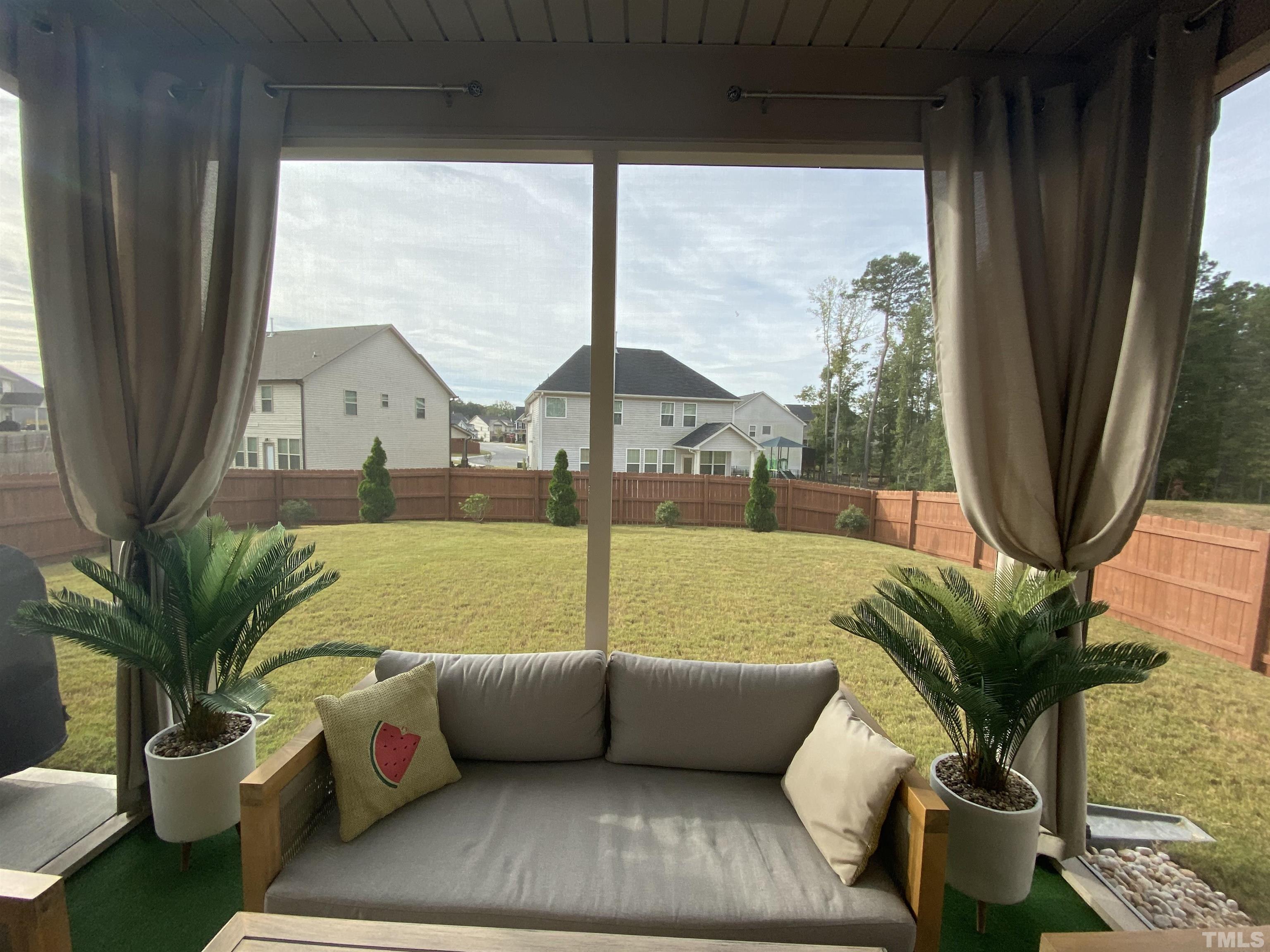 7435 Randshire Way Raleigh, NC 27616 - Photo 6 of 25 a living room with furniture and a floor to ceiling window