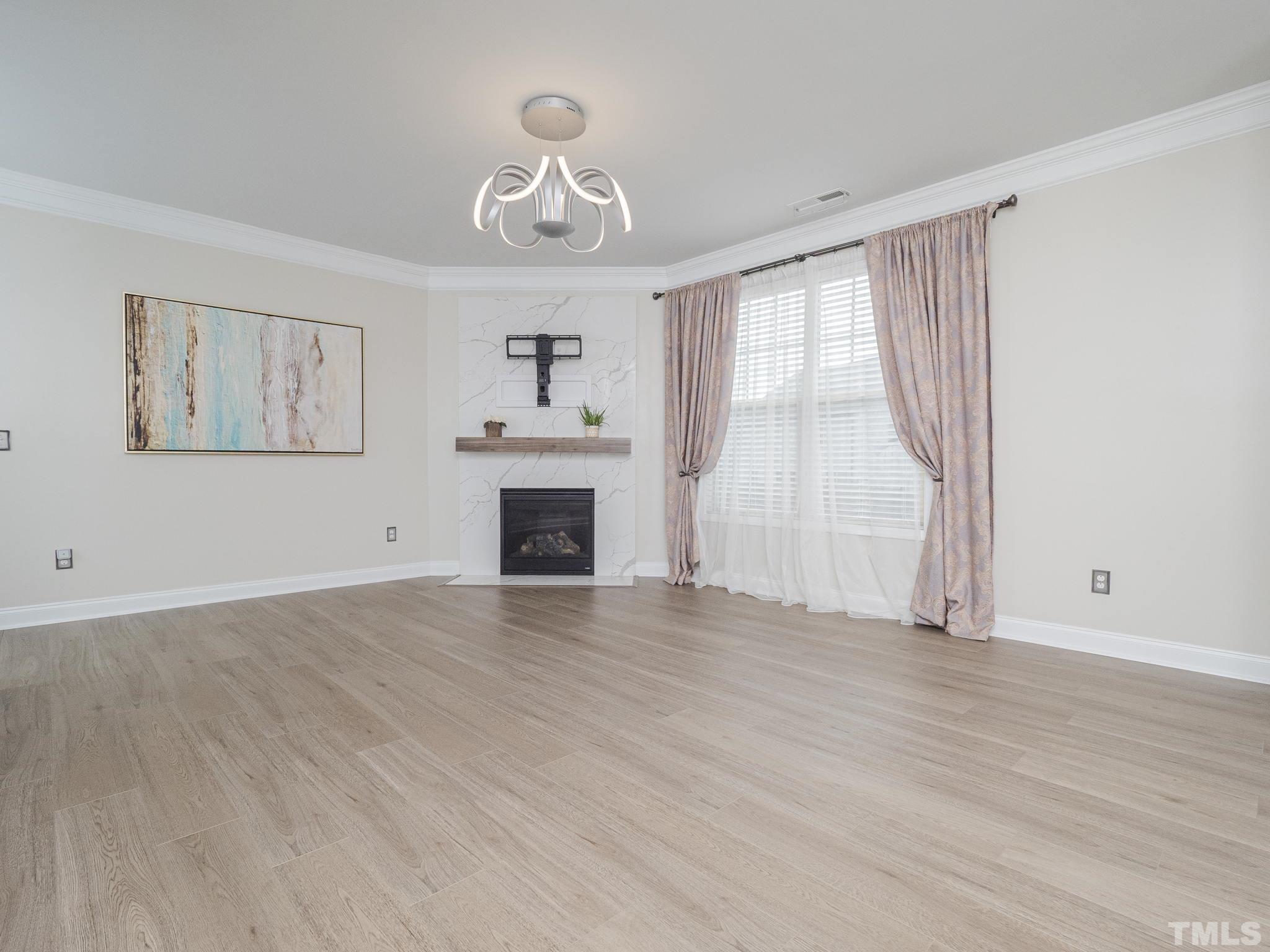 7435 Randshire Way Raleigh, NC 27616 - Photo 7 of 25 an empty room with windows and fireplace