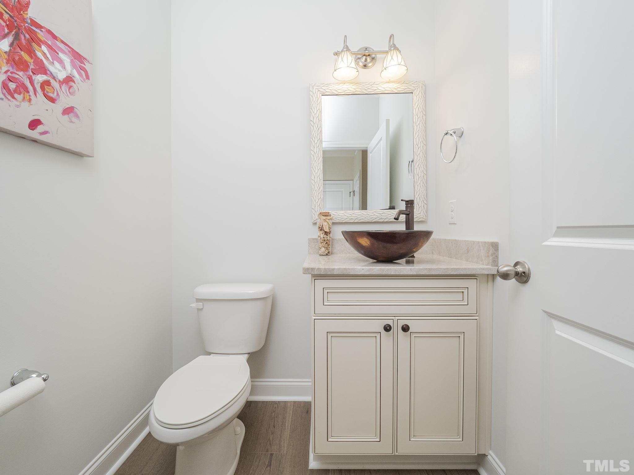 7435 Randshire Way Raleigh, NC 27616 - Photo 9 of 25 a bathroom with a toilet sink and mirror