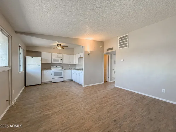 a view of a kitchen with refrigerator and microwave