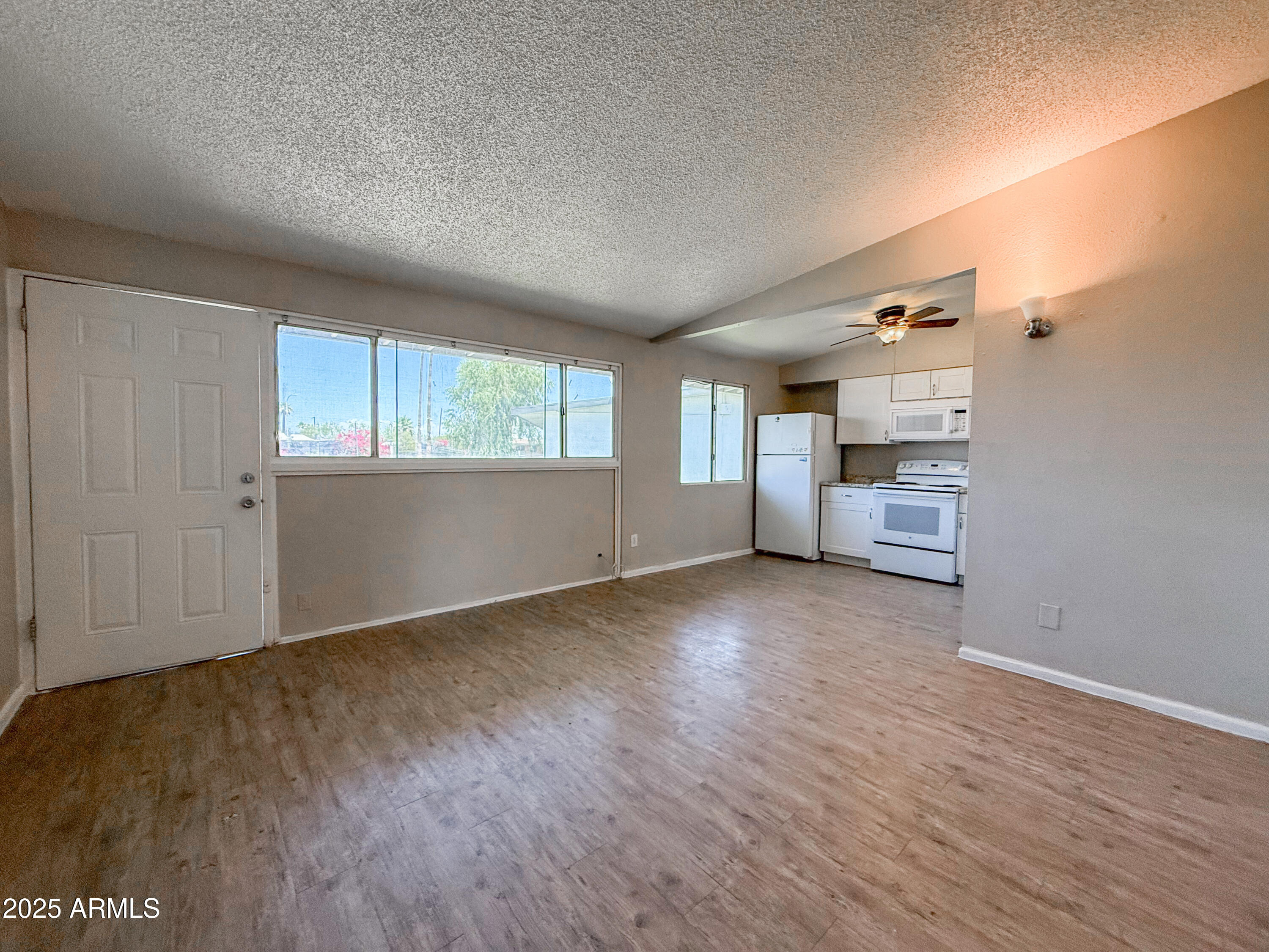 2139 West Devonshire Avenue, Unit 3 Phoenix, AZ 85015 - Photo 5 of 13 wooden floor in an empty room with a window