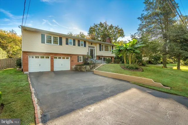 a view of a big house with a yard and plants