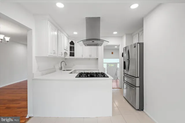 a kitchen with stainless steel appliances granite countertop a stove and a refrigerator