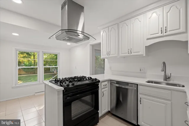 a kitchen with appliances cabinets and a window