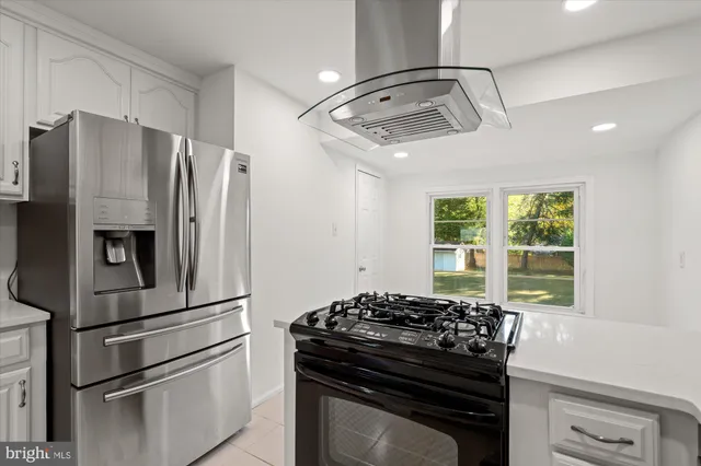 a view of a hallway with wooden floor and entryway