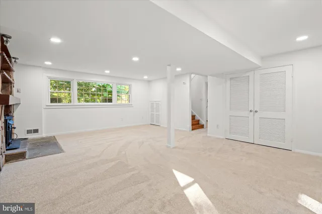 a view of empty room with wooden floor and fireplace
