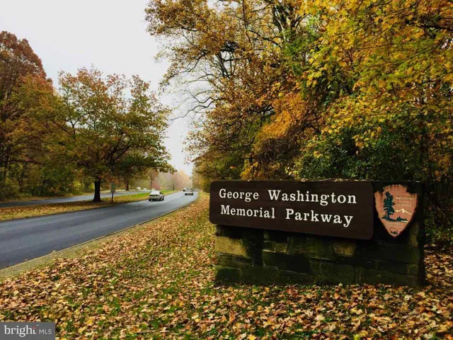 a view of a swimming pool with a yard and sitting space
