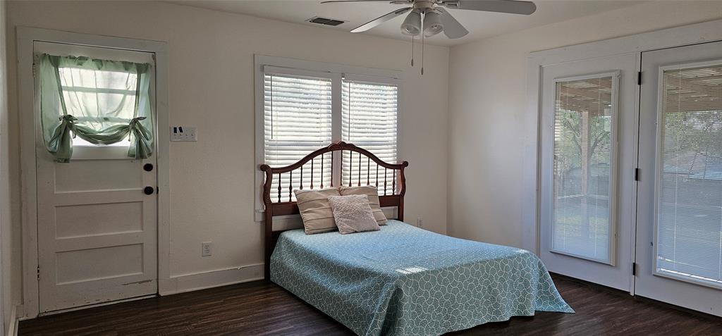 700 Live Oak Road Canton, TX 75103 - Photo 14 of 28 a bedroom with a bed and wooden floor