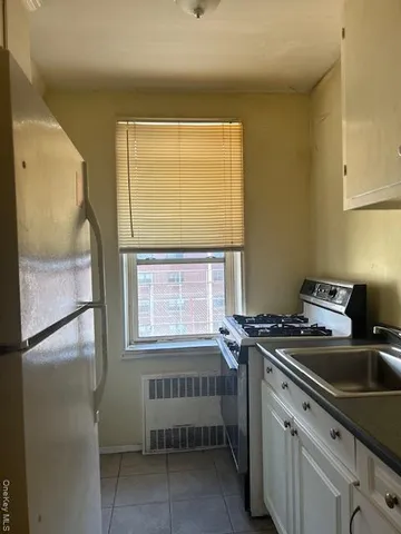 a bathroom with a sink a window and a shower