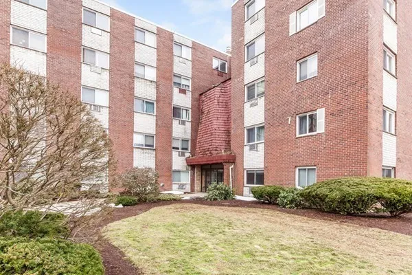 a view of a brick building next to a yard